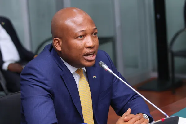 Ghana U.S. Deportee MoU debate as MP Samuel Okudzeto Ablakwa speaks into a microphone during Parliament session