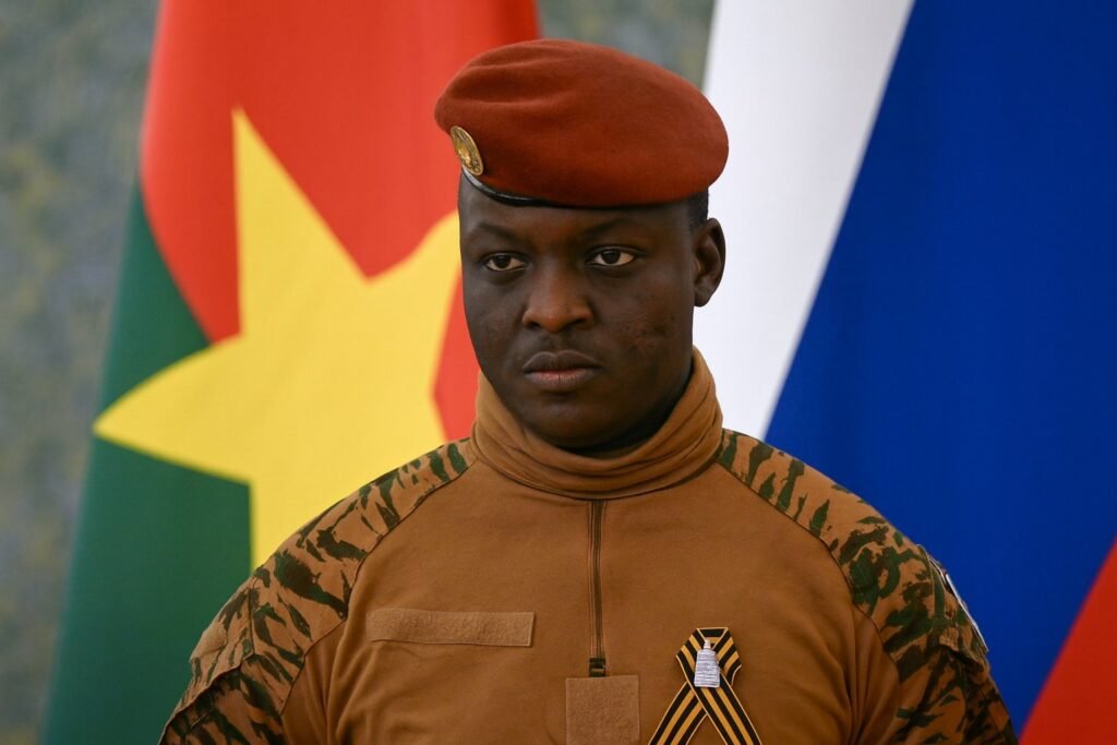 Burkina Faso Visa-Free Access announcement with military officer standing before national flag, symbolizing new 2025 open-border policy.