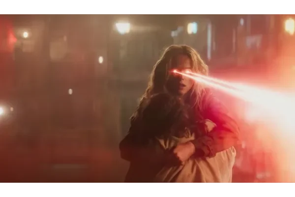 Supergirl trailer scene showing Kara Zor-El using her heat vision while protecting a child